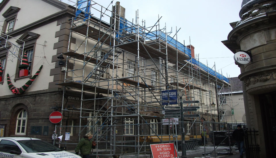 Scaffolding with a stair tower on the front of the Guildhall in Brecon, a Brecon Scaffolding car parked in front